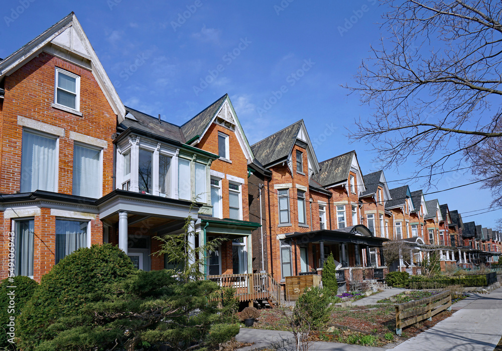 Long row of narrow old urban houses with gables