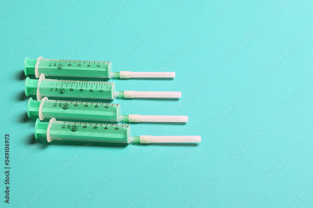 Top view of different syringes for injection on colorful background. Medical equipment concept with copy space Top view of different syringes for injection on colorful background. Medical equipment concept with copy space