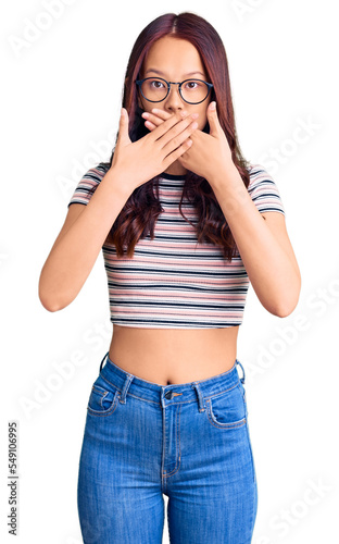 Young beautiful chinese girl wearing casual clothes shocked covering mouth with hands for mistake. secret concept.