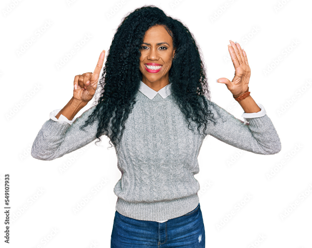 Middle age african american woman wearing casual clothes showing and pointing up with fingers number six while smiling confident and happy. Middle age african american woman wearing casual clothes showing and pointing up with fingers number six while smiling confident and happy.