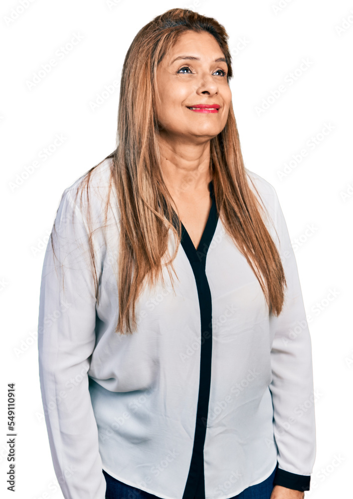 Middle age latin woman wearing business shirt looking away to side with smile on face, natural expression. laughing confident. Middle age latin woman wearing business shirt looking away to side with smile on face, natural expression. laughing confident.