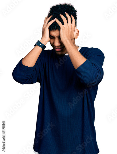 Young african american man wearing casual clothes suffering from headache desperate and stressed because pain and migraine. hands on head.