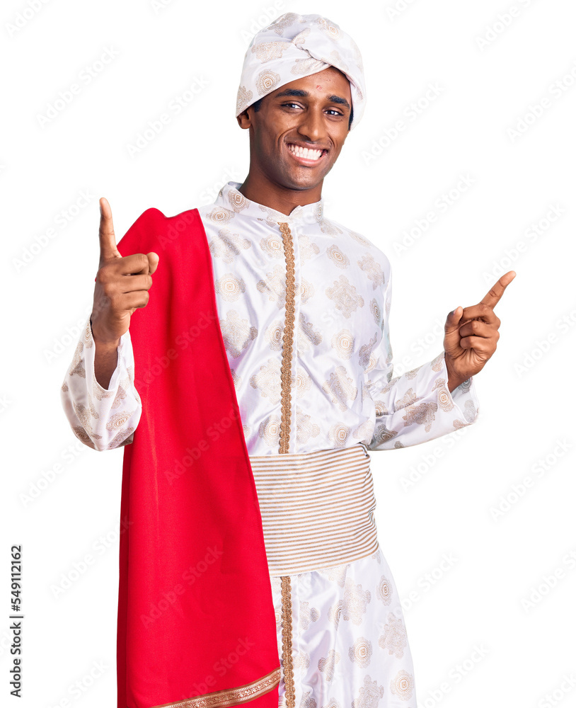 African handsome man wearing tradition sherwani saree clothes smiling confident pointing with fingers to different directions. copy space for advertisement African handsome man wearing tradition sherwani saree clothes smiling confident pointing with fingers to different directions. copy space for advertisement