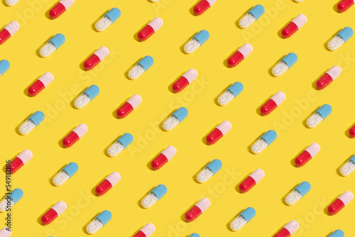 Two types of medicine pills on yellow background. Pill pattern