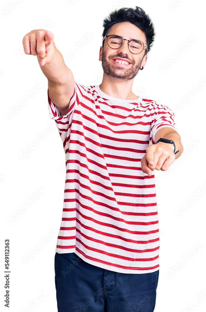 Naklejka premium Young hispanic man wearing casual clothes pointing to you and the camera with fingers, smiling positive and cheerful