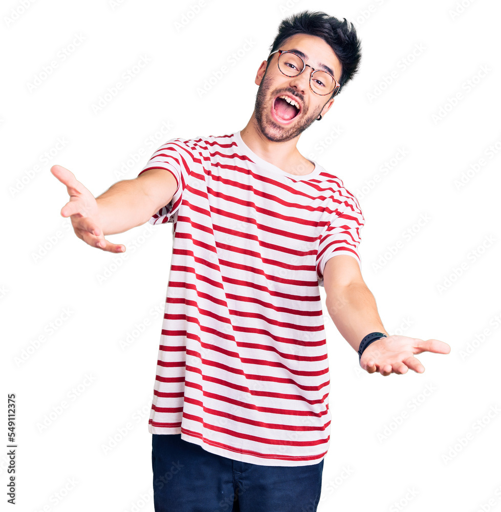 Young hispanic man wearing casual clothes smiling cheerful offering hands giving assistance and acceptance. Young hispanic man wearing casual clothes smiling cheerful offering hands giving assistance and acceptance.