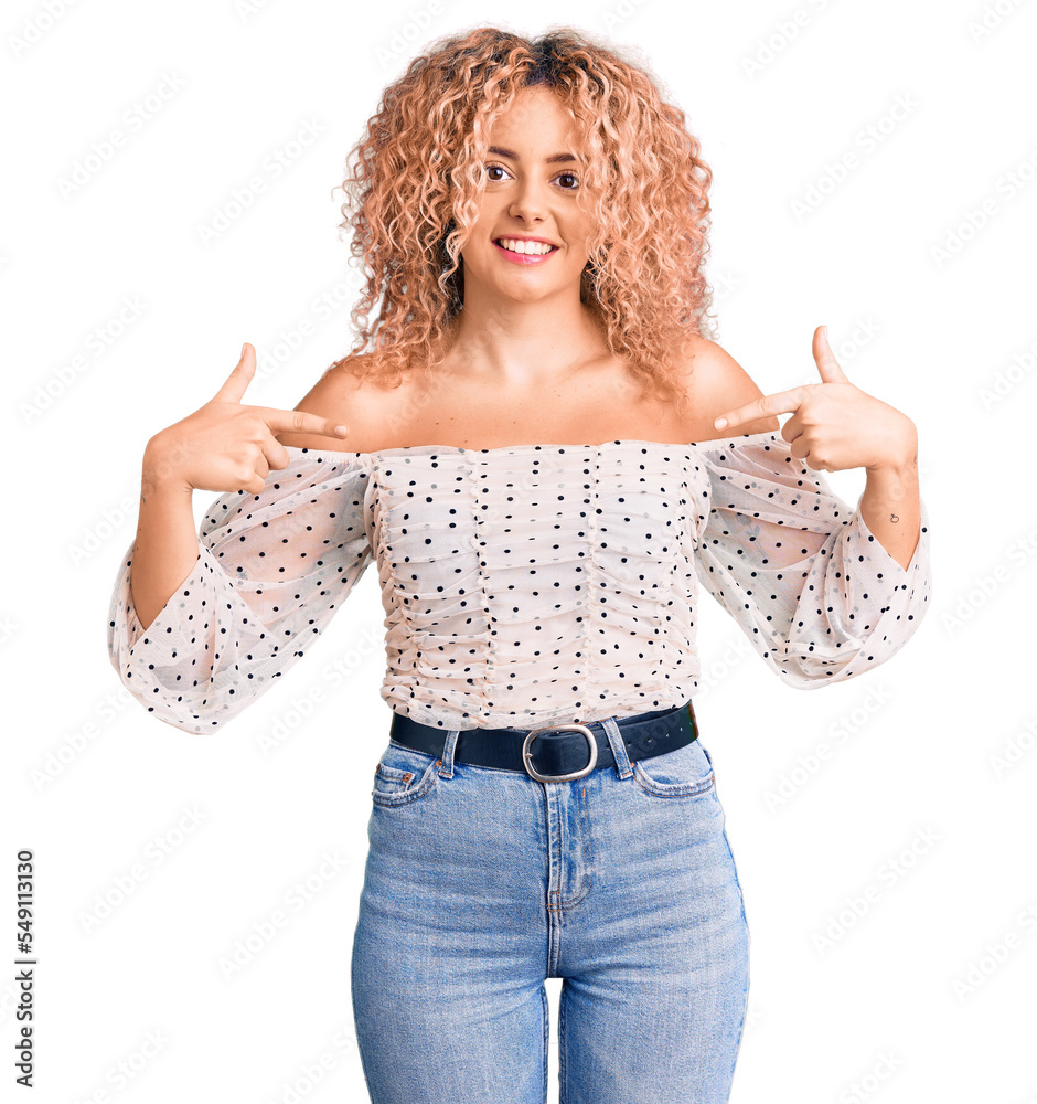 Young blonde woman with curly hair wearing casual clothes looking confident with smile on face, pointing oneself with fingers proud and happy. Young blonde woman with curly hair wearing casual clothes looking confident with smile on face, pointing oneself with fingers proud and happy.