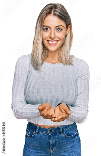 Beautiful blonde woman wearing casual clothes smiling with hands palms together receiving or giving gesture. hold and protection