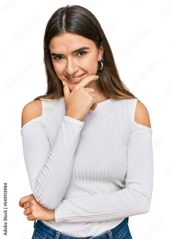 Young hispanic woman wearing casual clothes looking confident at the camera smiling with crossed arms and hand raised on chin. thinking positive. Young hispanic woman wearing casual clothes looking confident at the camera smiling with crossed arms and hand raised on chin. thinking positive.