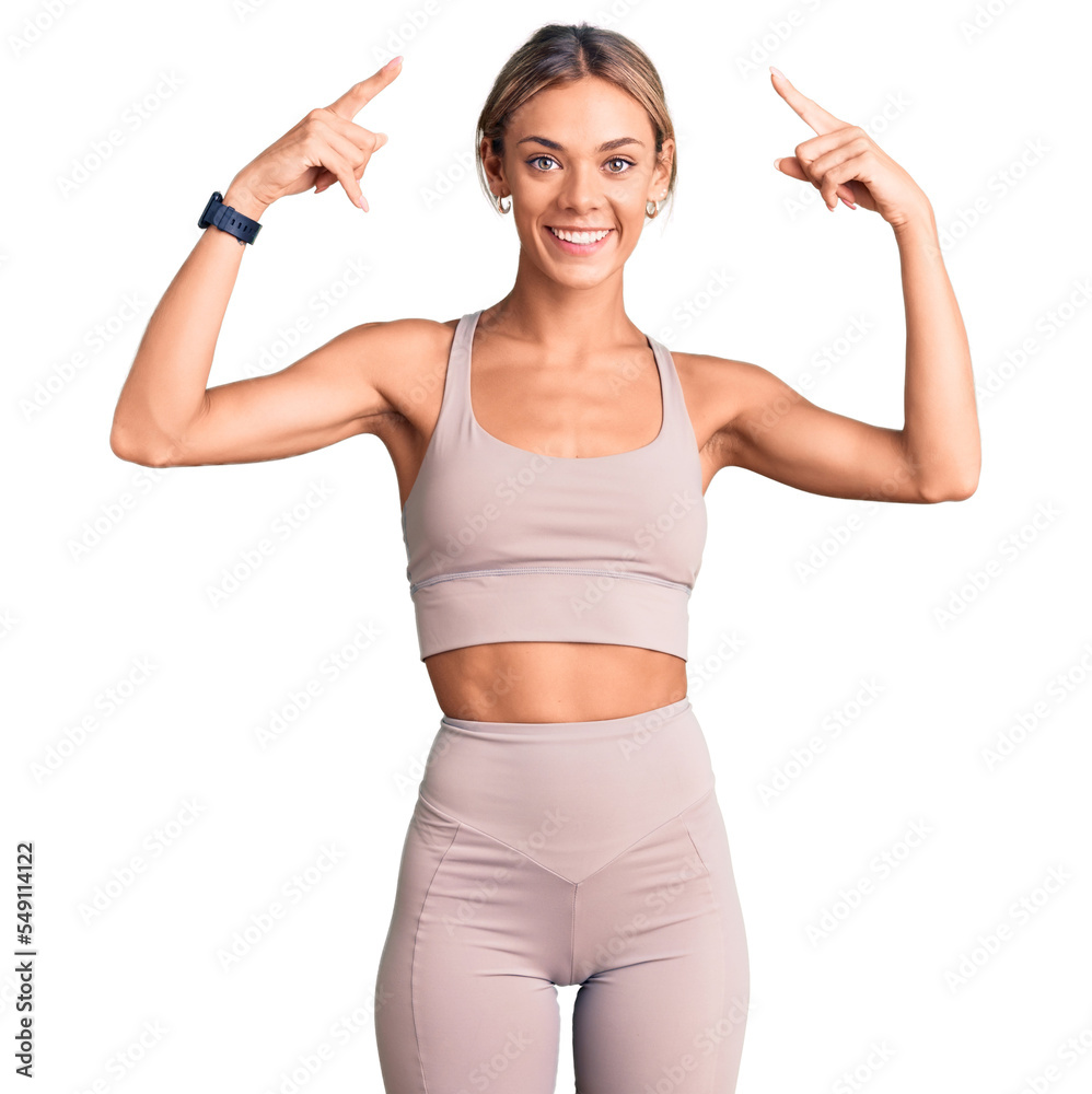 Beautiful caucasian woman wearing sportswear smiling pointing to head with both hands finger, great idea or thought, good memory Beautiful caucasian woman wearing sportswear smiling pointing to head with both hands finger, great idea or thought, good memory