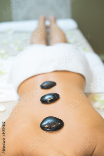 stones on the back in a stone therapy room