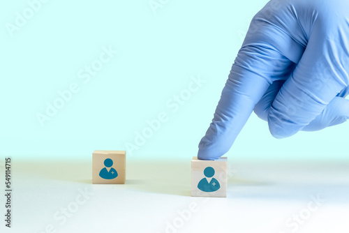 Recruitment of doctors and Human Resources Management, selection of qualified personnel for the work team. Selection of the qualified physician. hand and wooden cubes