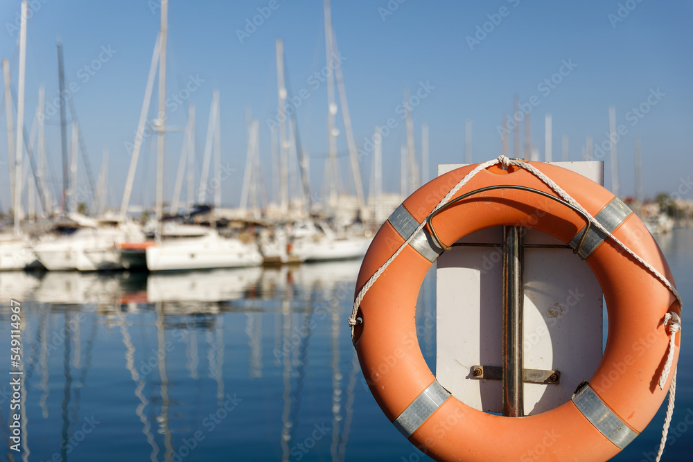 Lifebuoy on the background of the marina and yachts