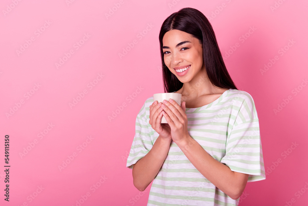 Portrait of pretty positive girl beaming smile arms hold coffee cup isolated on pink color background Portrait of pretty positive girl beaming smile arms hold coffee cup isolated on pink color background