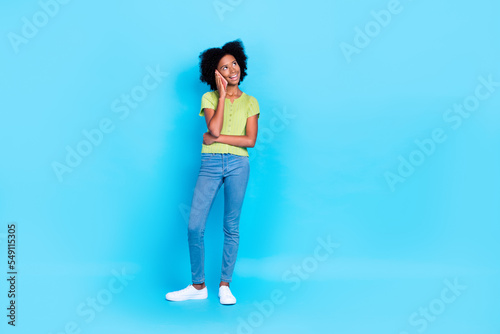 Full body length size photo of youngster teenager dreamy looking minded empty space speaking telegram call isolated on bright blue color background