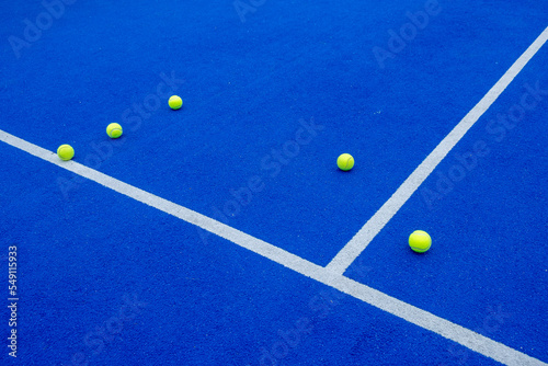 Obraz na plátně padel tennis balls on a blue court, racket sports concept