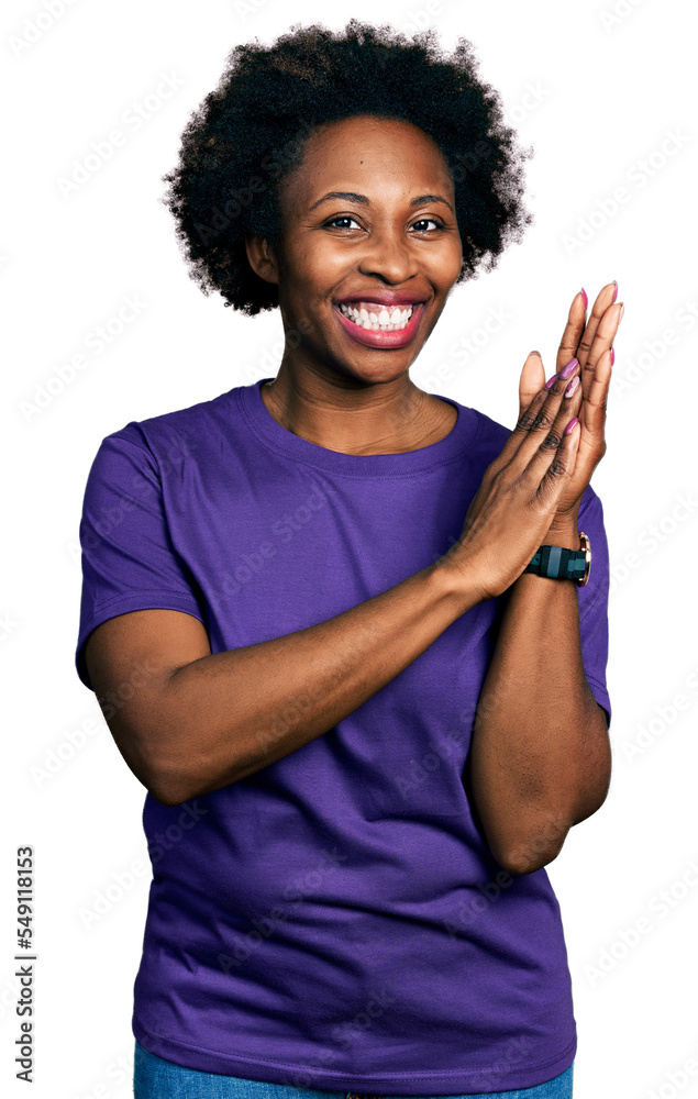 African american woman with afro hair wearing casual purple t shirt clapping and applauding happy and joyful, smiling proud hands together African american woman with afro hair wearing casual purple t shirt clapping and applauding happy and joyful, smiling proud hands together