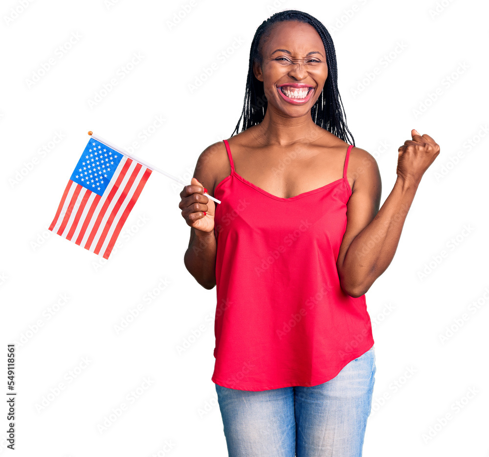 Young african american woman holding united states flag screaming proud, celebrating victory and success very excited with raised arms Young african american woman holding united states flag screaming proud, celebrating victory and success very excited with raised arms