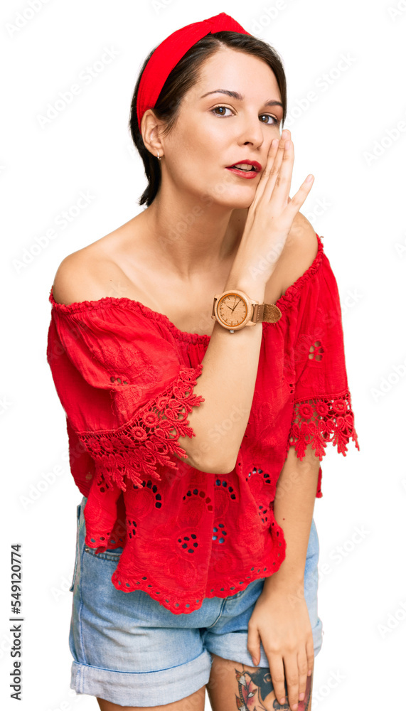 Young brunette woman with short hair wearing casual summer clothes and diadem hand on mouth telling secret rumor, whispering malicious talk conversation Young brunette woman with short hair wearing casual summer clothes and diadem hand on mouth telling secret rumor, whispering malicious talk conversation