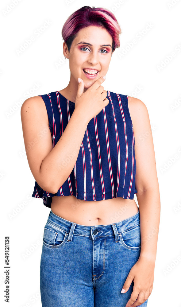 Young beautiful woman with pink hair wearing casual clothes looking confident at the camera smiling with crossed arms and hand raised on chin. thinking positive. Young beautiful woman with pink hair wearing casual clothes looking confident at the camera smiling with crossed arms and hand raised on chin. thinking positive.