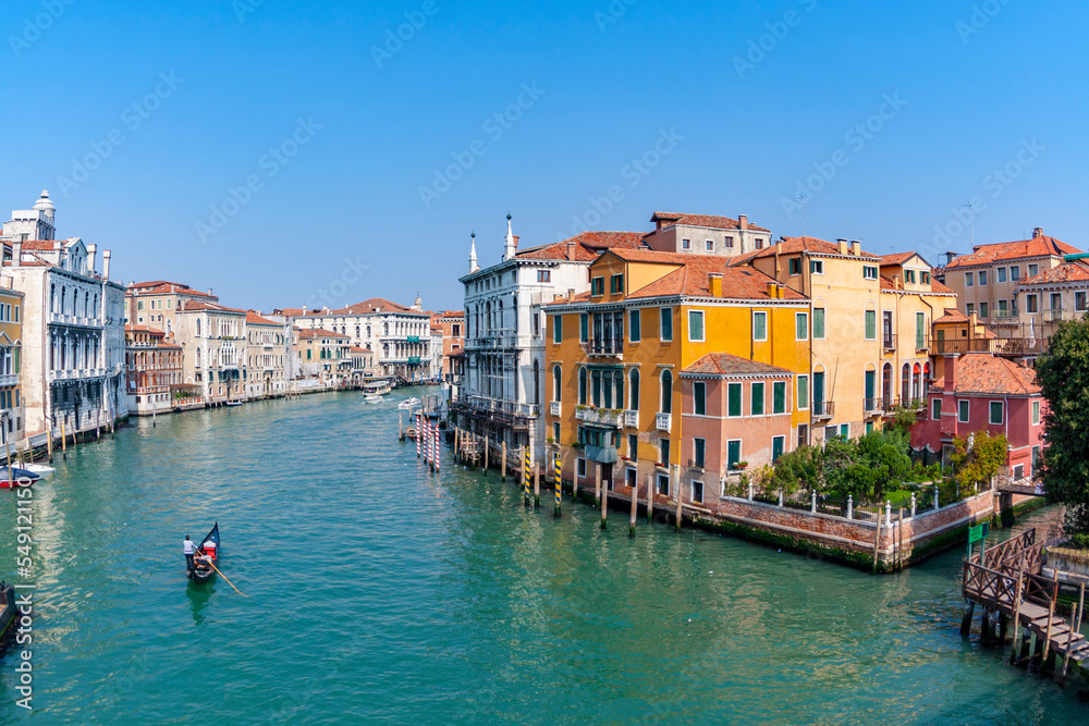 people enjoy the gondola trip in the Canale Grande in Venice