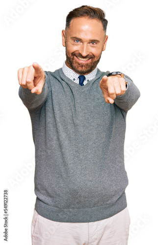 Handsome middle age man wearing business clothes pointing to you and the camera with fingers, smiling positive and cheerful