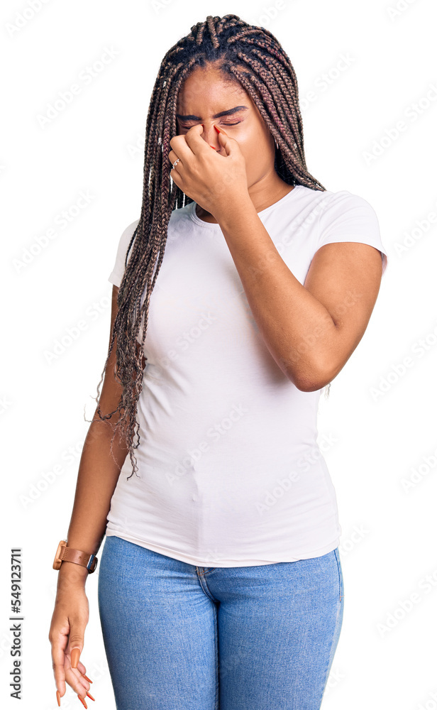 Young african american woman with braids wearing casual clothes tired rubbing nose and eyes feeling fatigue and headache. stress and frustration concept. Young african american woman with braids wearing casual clothes tired rubbing nose and eyes feeling fatigue and headache. stress and frustration concept.