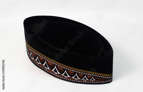 Closeup of a traditional Indonesian songkok cap made of black felt with decorative embroidery photo