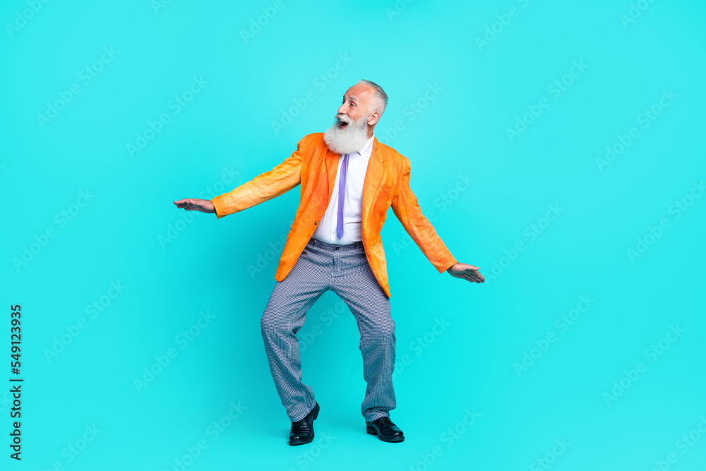Full length photo of pretty shocked pensioner guy wear neon orange jacket dancing empty space isolated teal color background Full length photo of pretty shocked pensioner guy wear neon orange jacket dancing empty space isolated teal color background