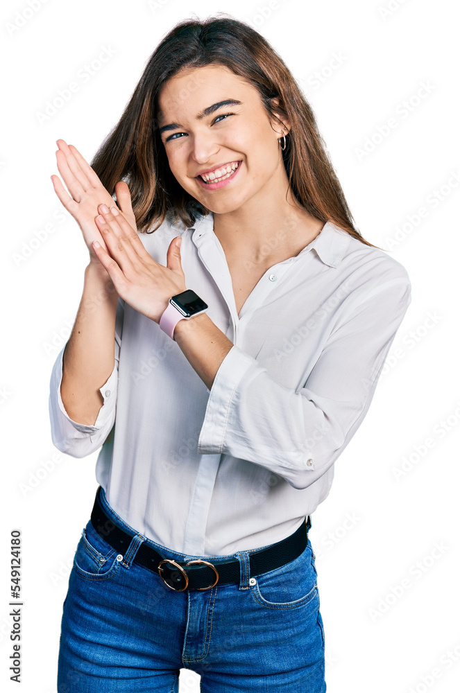 Young caucasian girl wearing casual white shirt clapping and applauding happy and joyful, smiling proud hands together Young caucasian girl wearing casual white shirt clapping and applauding happy and joyful, smiling proud hands together