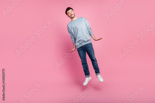 Full body size photo of young funny attractive handsome man wear casual clothes toothy hands like rocket launch hurry isolated on pink color background
