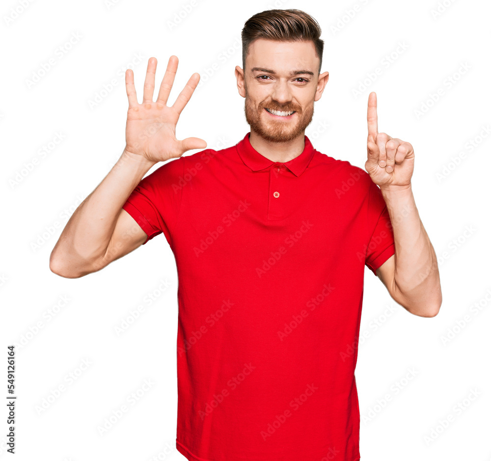 Fototapeta premium Young redhead man wearing casual clothes showing and pointing up with fingers number six while smiling confident and happy.