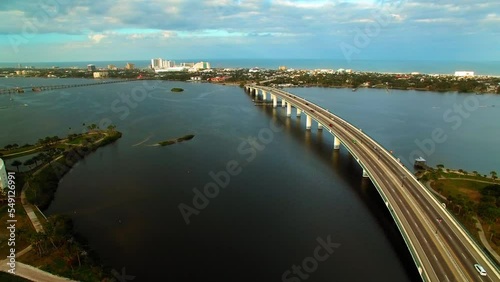 Wallpaper Mural Aerial Panning Shot Of Cars On Bridge Over Sea By News-Journal Center In City Under Cloudy Sky - Daytona Beach, Florida Torontodigital.ca