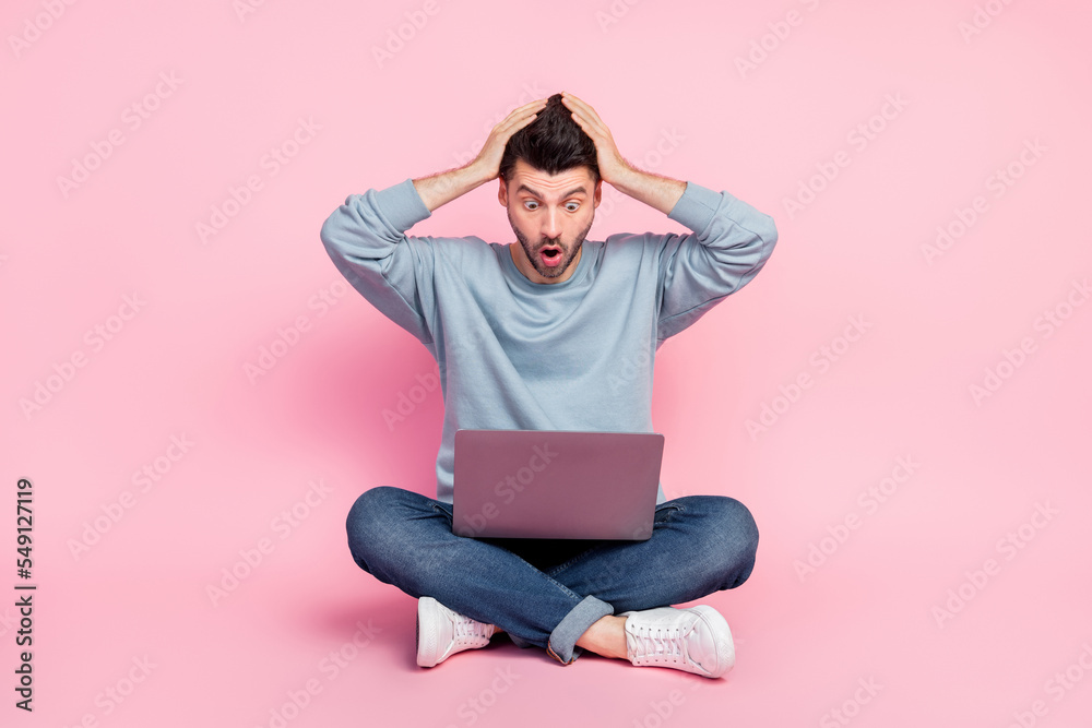 Full length photo of attractive young guy panic nervous programmer find bug dressed trendy blue clothes isolated on pink color background