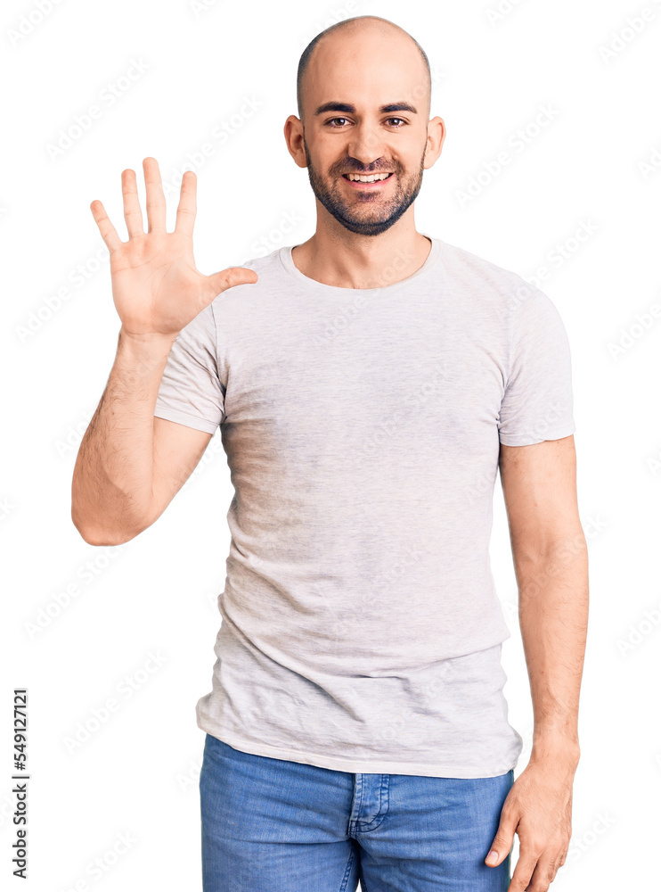 Young handsome man wearing casual t shirt showing and pointing up with fingers number five while smiling confident and happy. Young handsome man wearing casual t shirt showing and pointing up with fingers number five while smiling confident and happy.