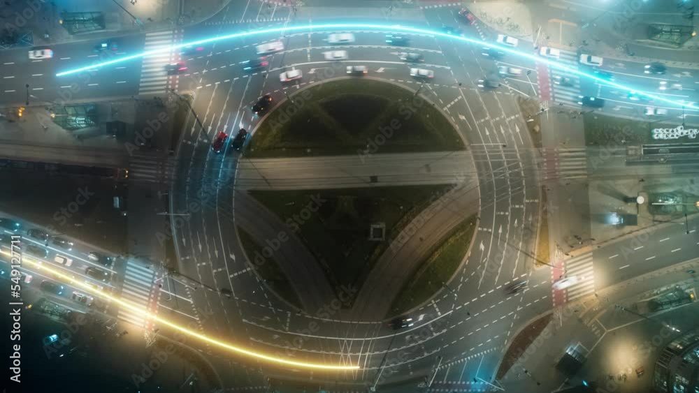 Aerial time lapse of a roundabout in the night with neon strokes ...