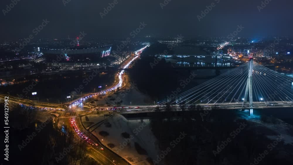 Aerial time-lapse panoramic drone shot of Warsaw city cityscape. Suspension cable bridge over Vistula river, downtown urban skyline in evening. Cinematic Warsaw panorama at night Aerial time-lapse panoramic drone shot of Warsaw city cityscape. Suspension cable bridge over Vistula river, downtown urban skyline in evening. Cinematic Warsaw panorama at night