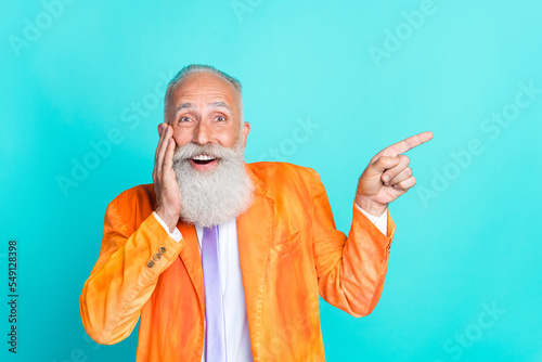 Photo of astonished retired mister stylish rerto clothes arm direct empty space impressed offer isolated on cyan color background photo