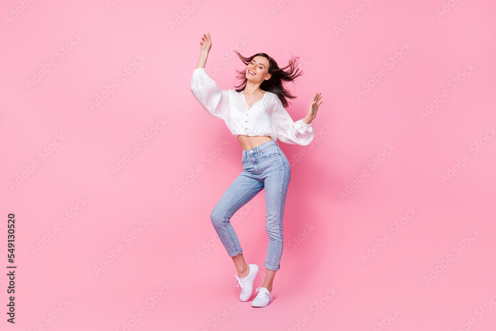 Full body photo of lovely young lady dancing feeling free comfort lightness dressed stylish white outfit isolated on pink color background
