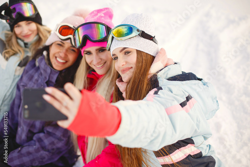 Group of girls taking selfies in mountains on skis