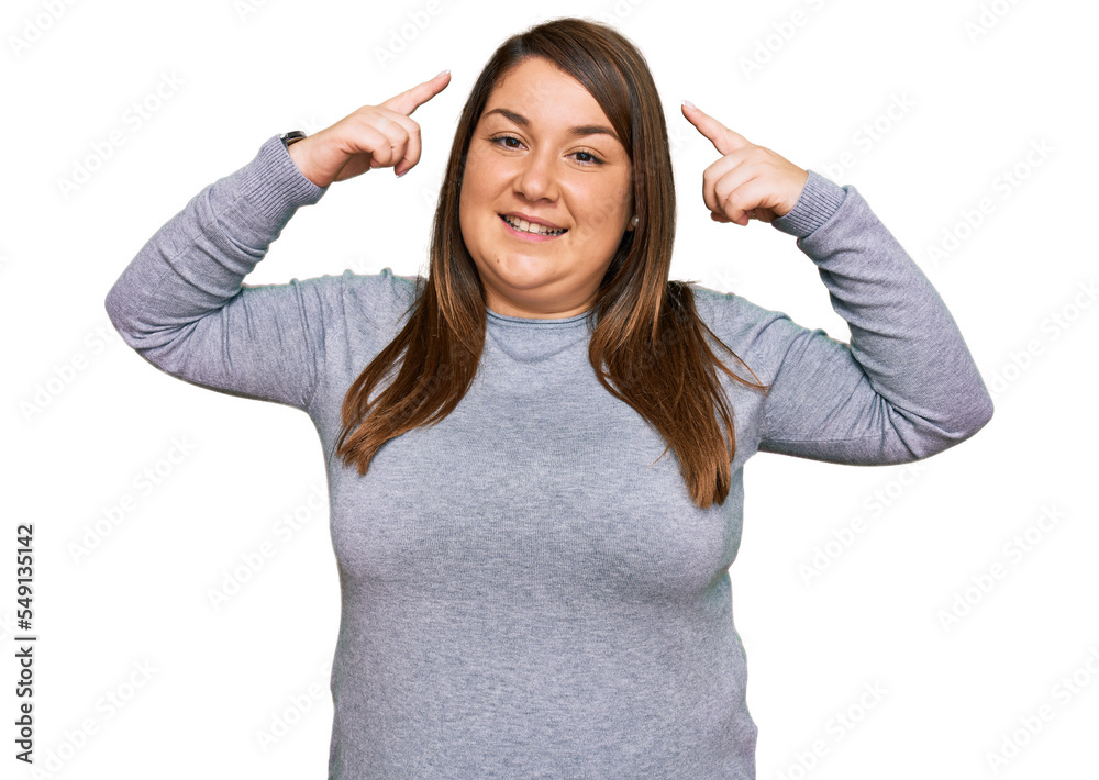 Beautiful brunette plus size woman wearing casual clothes smiling pointing to head with both hands finger, great idea or thought, good memory Beautiful brunette plus size woman wearing casual clothes smiling pointing to head with both hands finger, great idea or thought, good memory