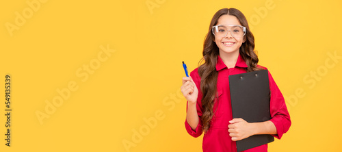 Architect teenager girl. ready with the results. happy childhood. teen girl wear eyeglasses. kid make notes in folder. Child builder with protective glasses horizontal poster design.