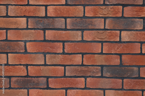 Decorative bricks on repaired wall as background, closeup