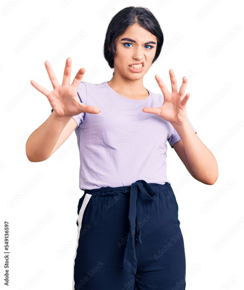 Brunette teenager girl wearing casual clothes afraid and terrified with fear expression stop gesture with hands, shouting in shock. panic concept. Brunette teenager girl wearing casual clothes afraid and terrified with fear expression stop gesture with hands, shouting in shock. panic concept.