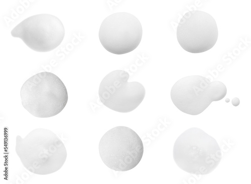 Set with drops of fluffy soap foam on white background, top view