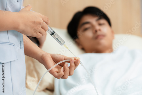 Quadro em tela Doctor and nurse inject medicine, dosage into IV tube providing medical treatment to patient in sterile room at hospital