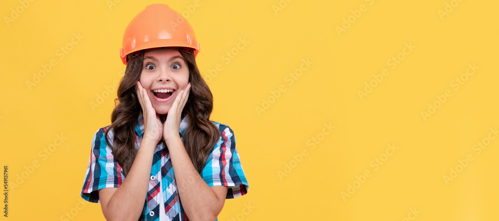 surprised teen girl with curly hair in construction helmet, carpenter. Child builder in helmet horizontal poster design. Banner header, copy space. surprised teen girl with curly hair in construction helmet, carpenter. Child builder in helmet horizontal poster design. Banner header, copy space.