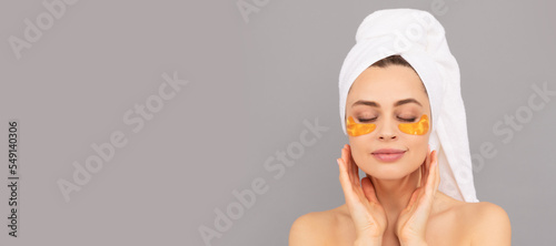 Obraz na plátně sensual lady with terry towel use facial golden eye patch for skin, hydrogel