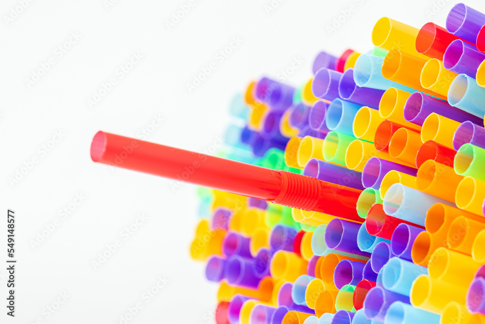 Fototapeta premium Heap of colorful plastic straws for drinks as background, closeup view macro plastic tubes, Fancy straw multicolor background