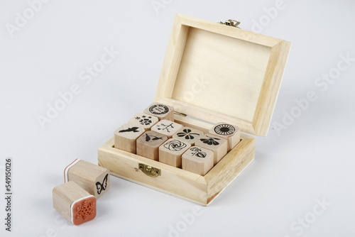 Various stamps and stamp designs in a wooden storage box